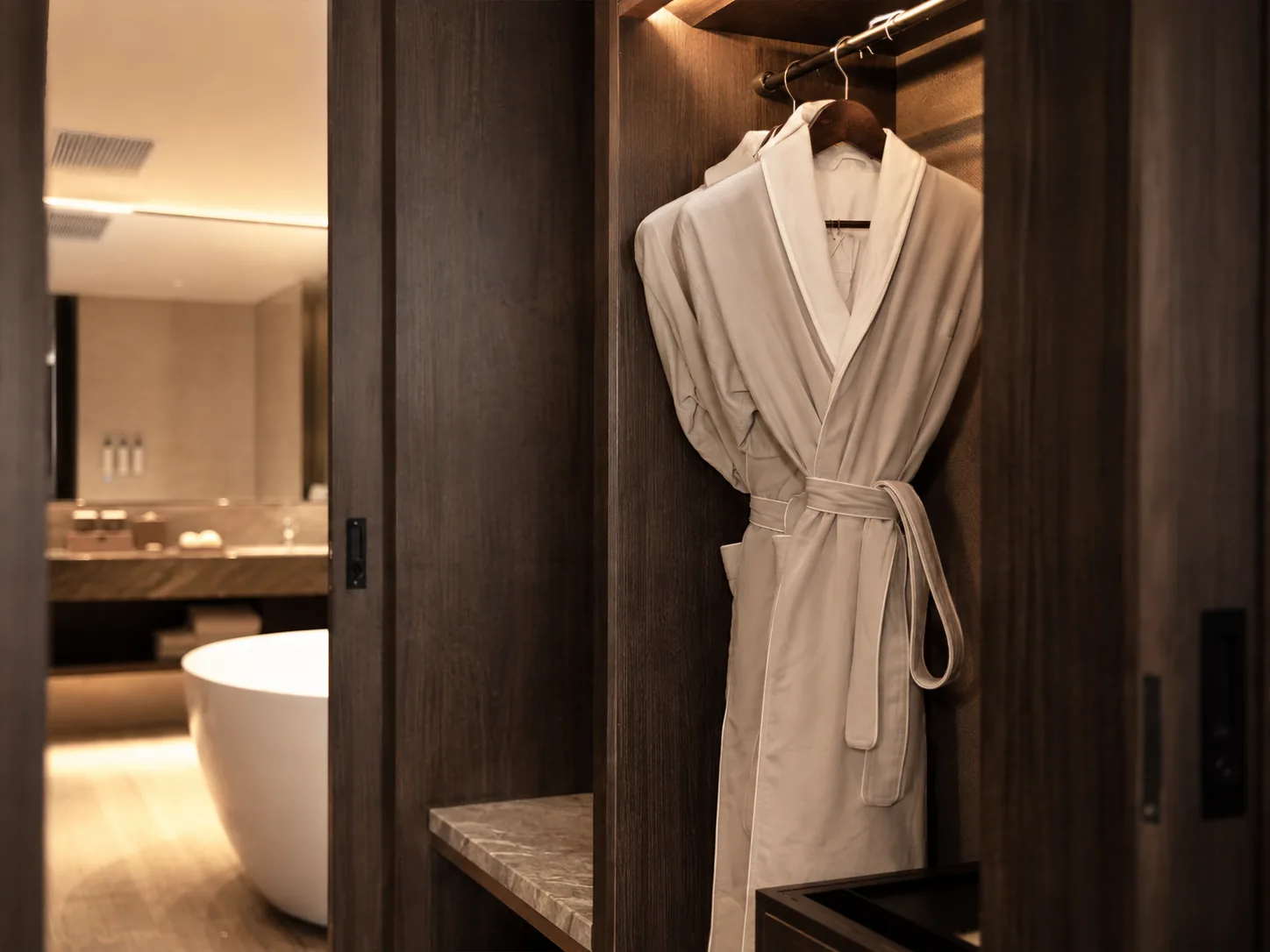 Integrated LED lighting and hanging rail detail in a custom hotel closet
