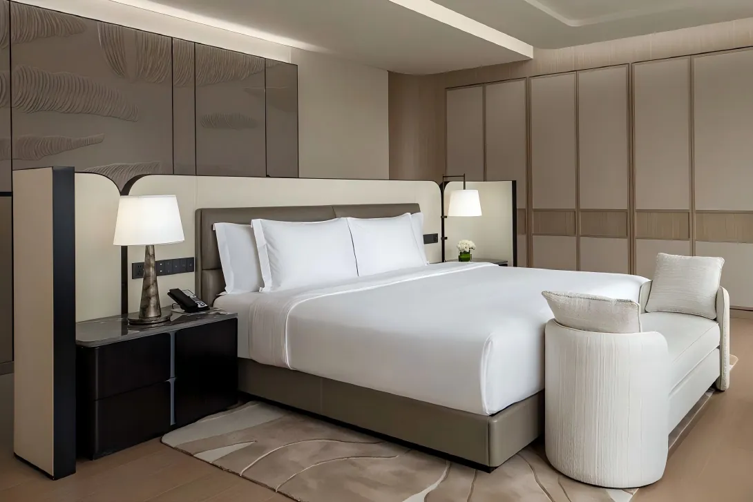 Complete hotel bed wall integration showing reading lights, sockets, and floating nightstands